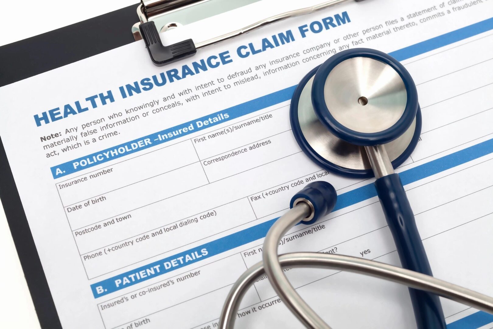 Health insurance form with stethoscope on clipboard.